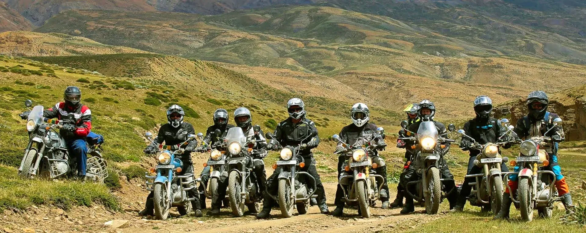 Group of riders on Royal Enfield motorcycles in the Himalayan foothills